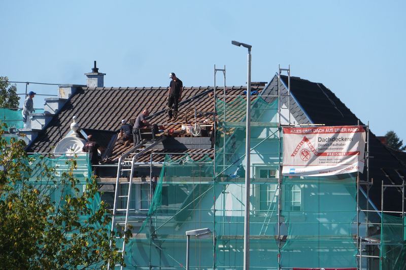 House being re-roofed behind scaffolding