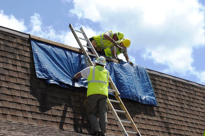 Tarp fixed over a damaged roof